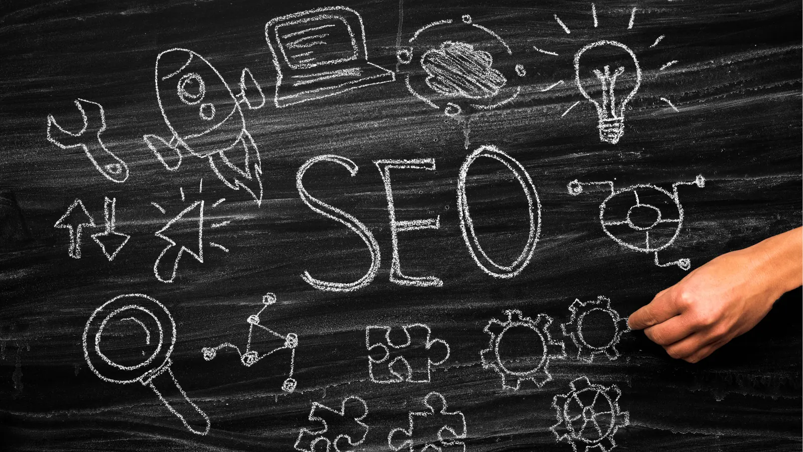 Hand drawing chalkboard SEO concept with rocket magnifying glass and gears