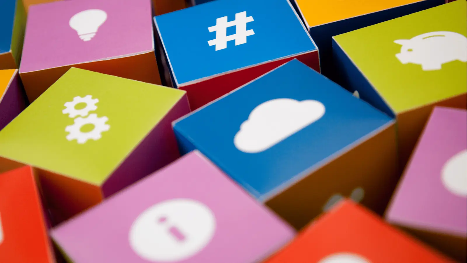 Close-up of colorful paper cubes with white technology and social icons