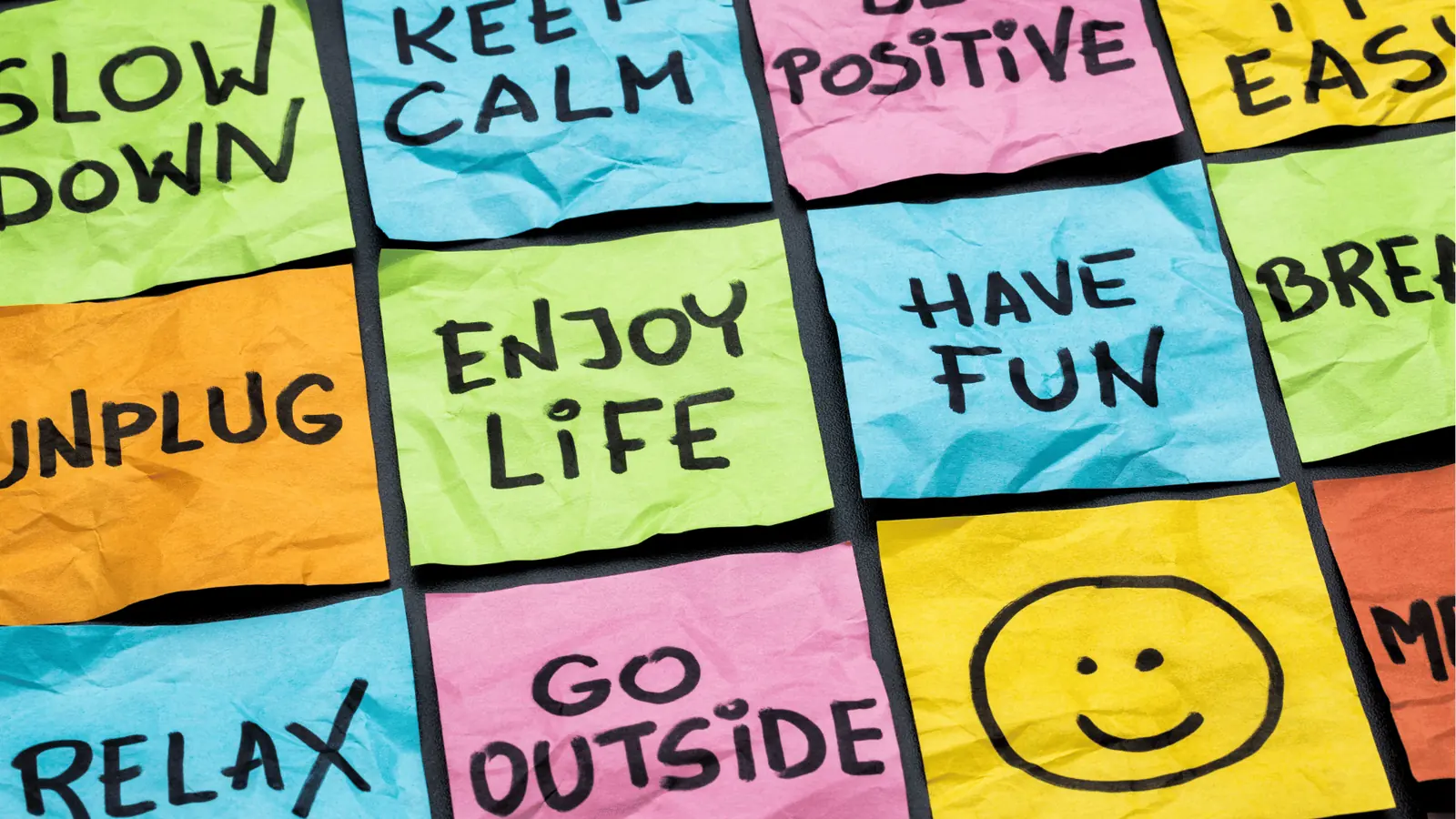 Colorful sticky notes with handwritten wellness messages and smiley face