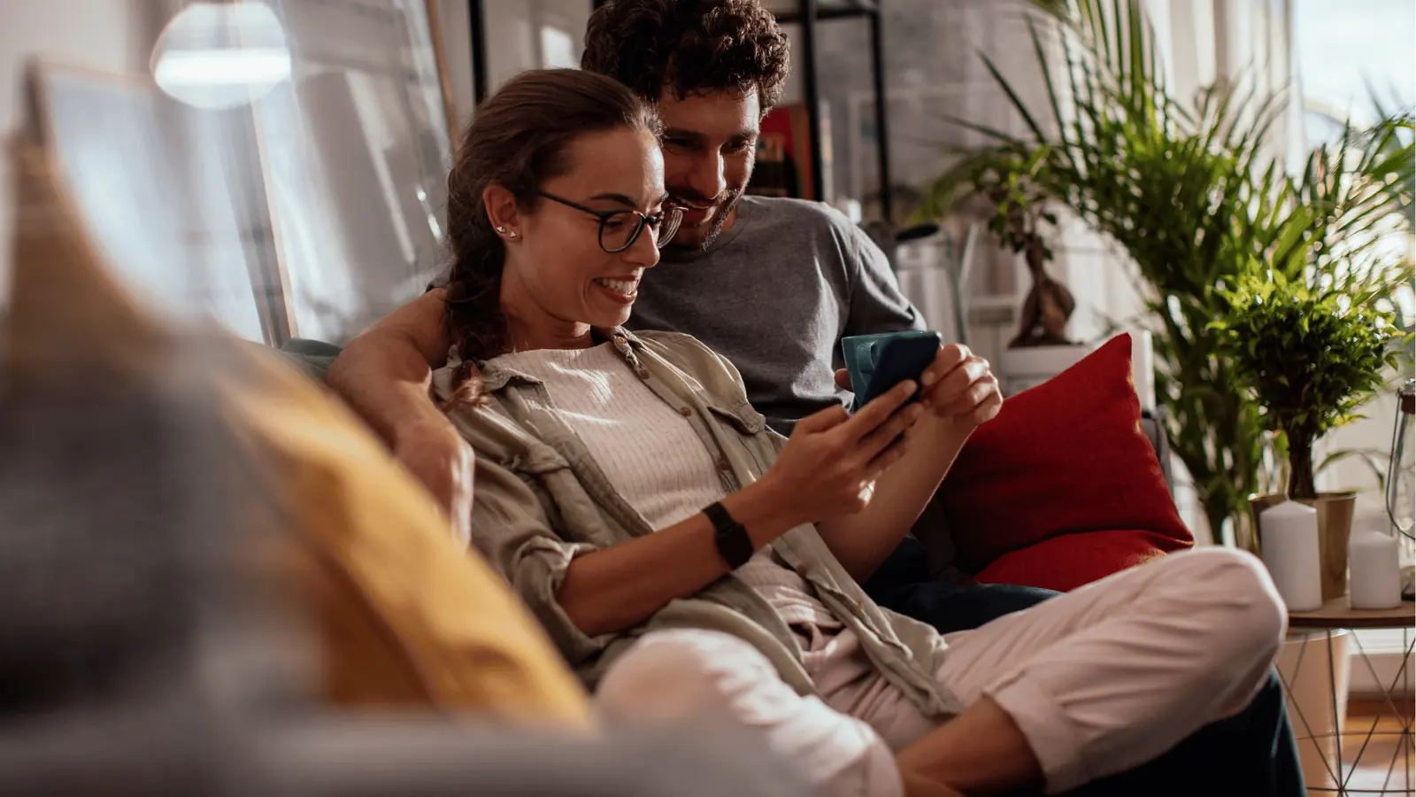Two people scrolling TikTok on a phone at home in the evening