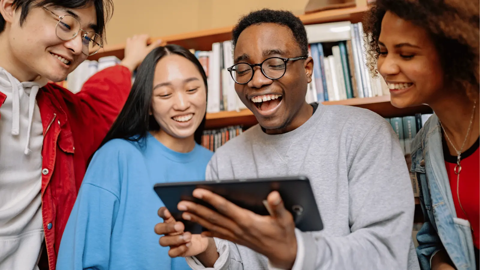 Team smiling around a tablet
