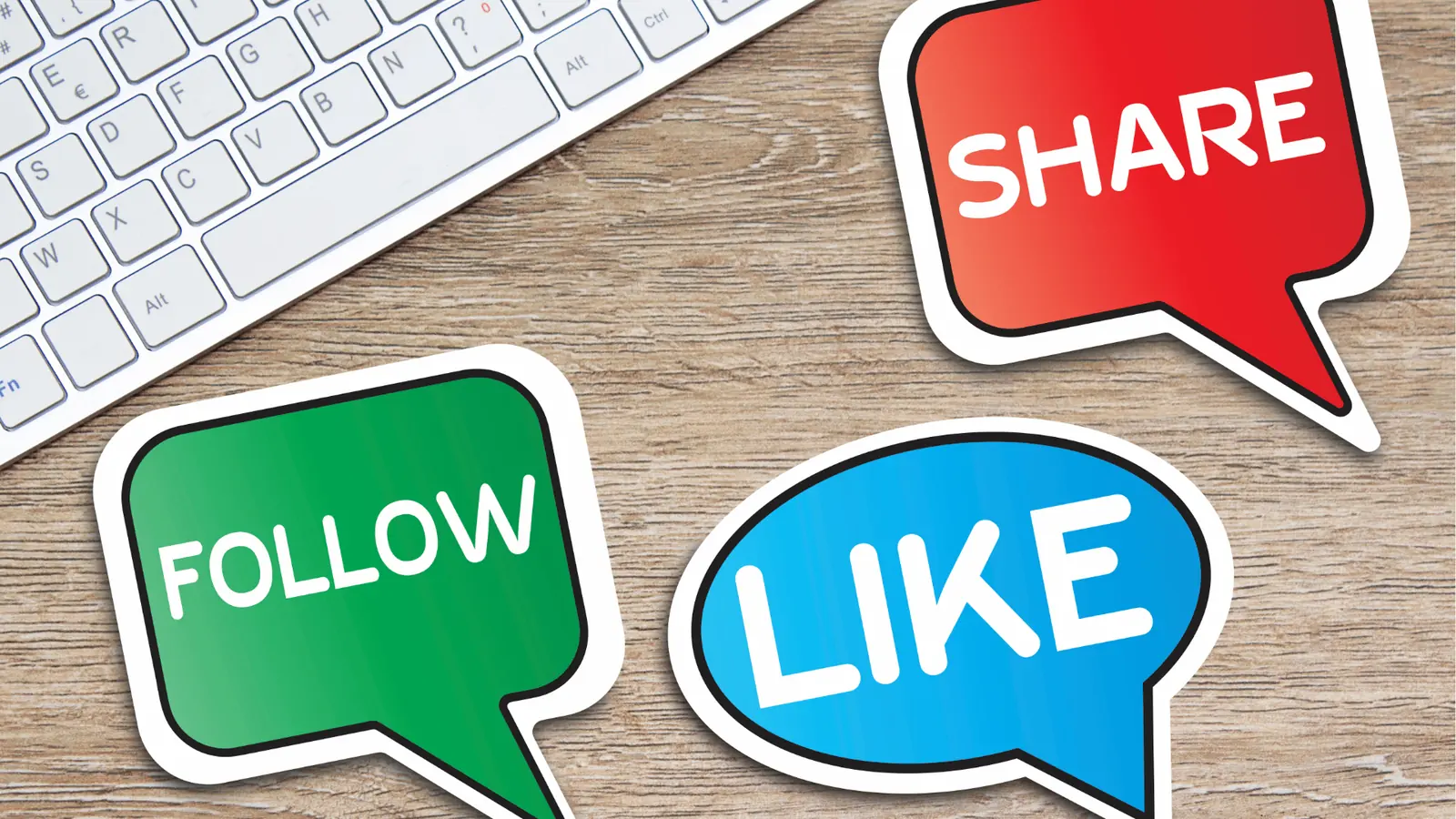 Three colorful speech-bubble stickers reading follow like share on wooden desk for content calendar