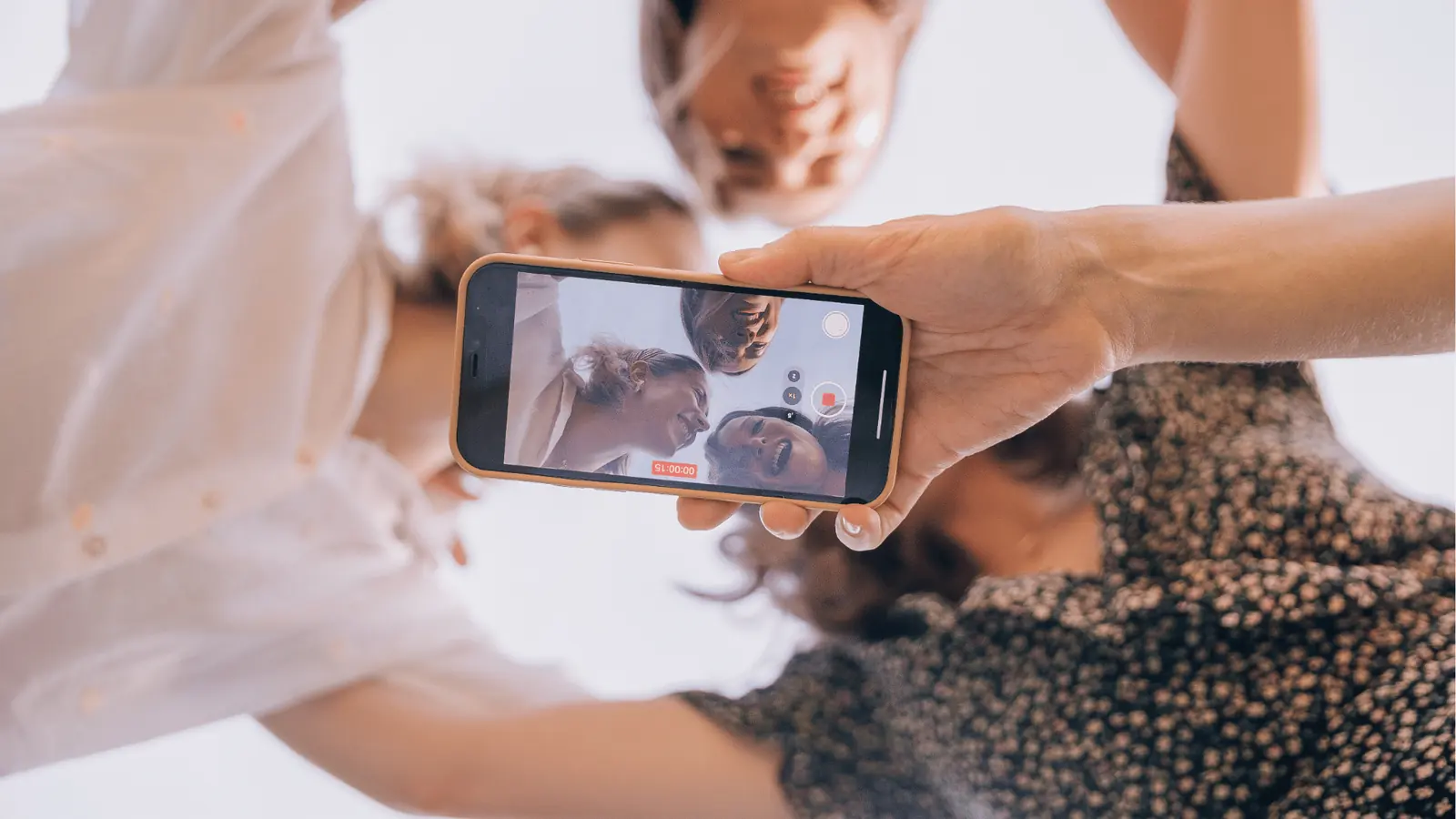 Group smiling into a selfie camera