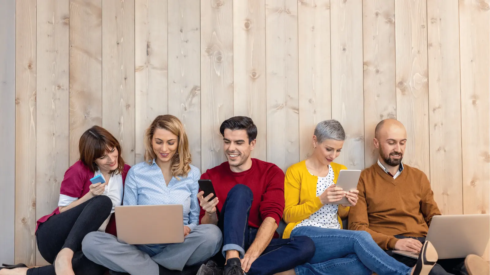 Happy group using their phones together