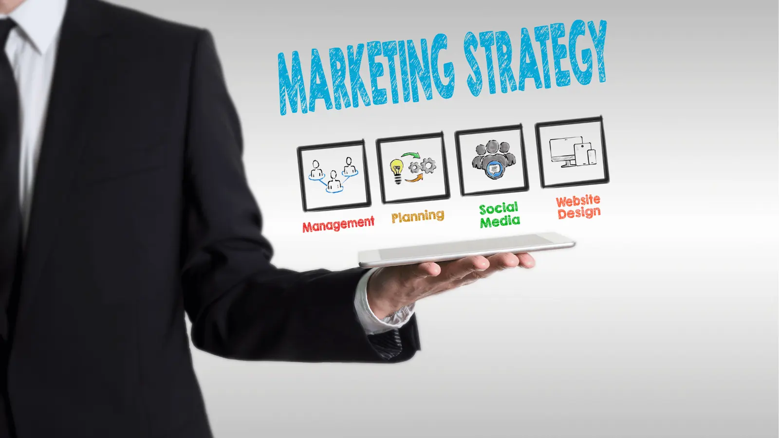 Businessman holding tablet with marketing strategy icons and labels above