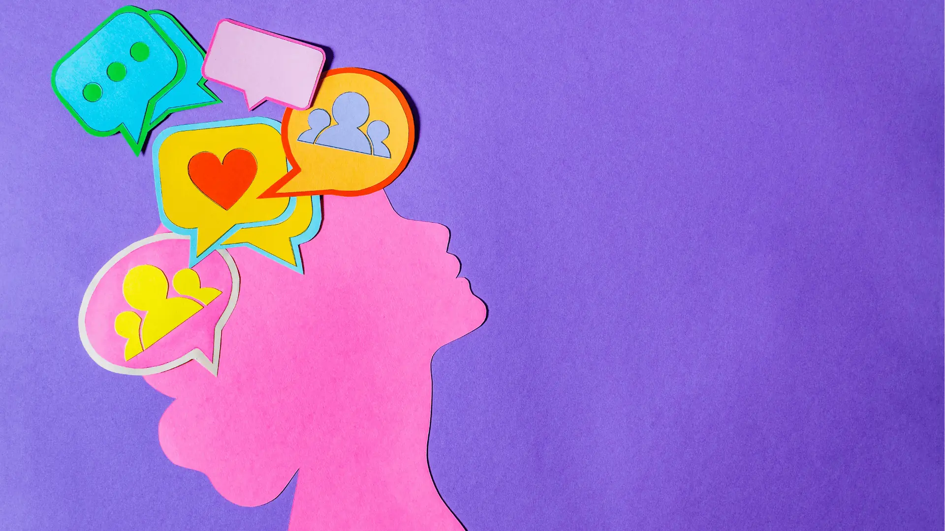 Paper-cut pink profile silhouette with colorful speech bubbles and social icons
