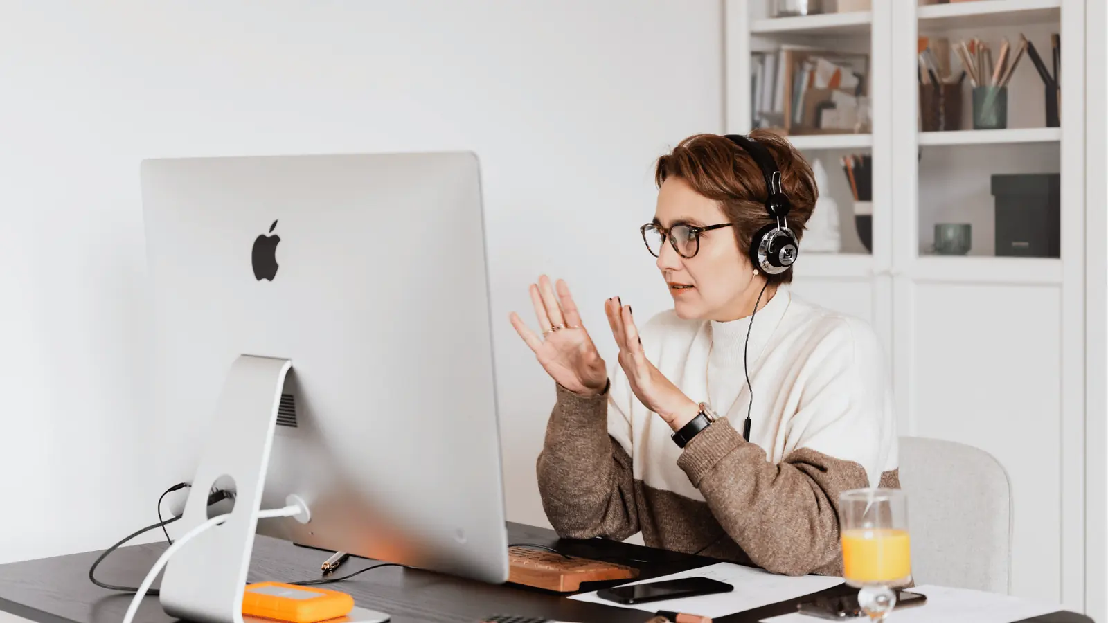 Freelance social media manager on a video call with a client from a home office
