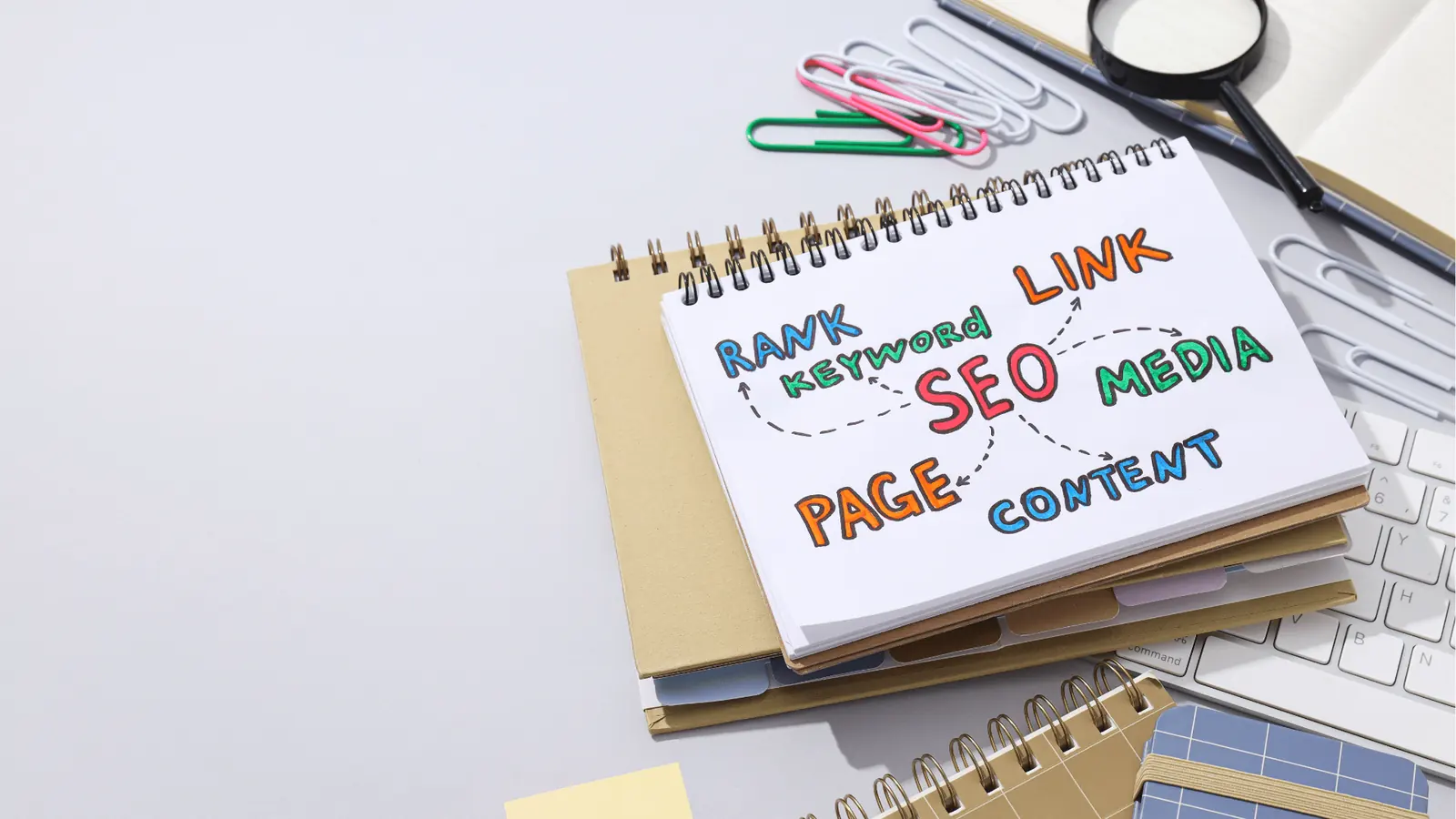 Spiral notebook with colorful hand-drawn SEO mindmap on desk for planning