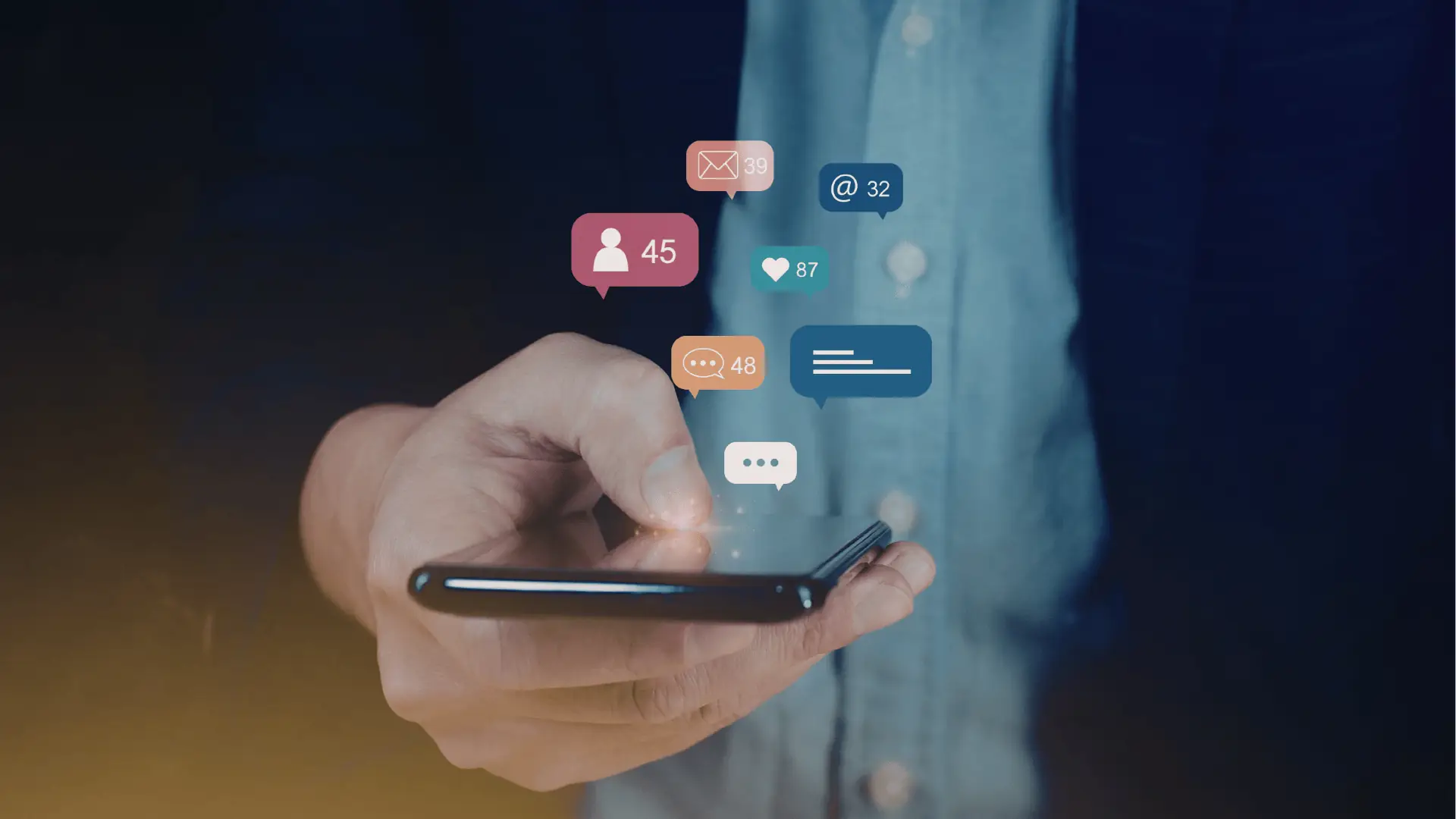 Hand holding smartphone with floating social media notification icons above screen for asset management