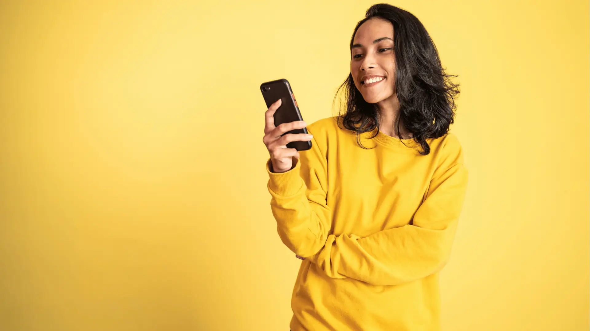 Happy social media manager smiling at her phone