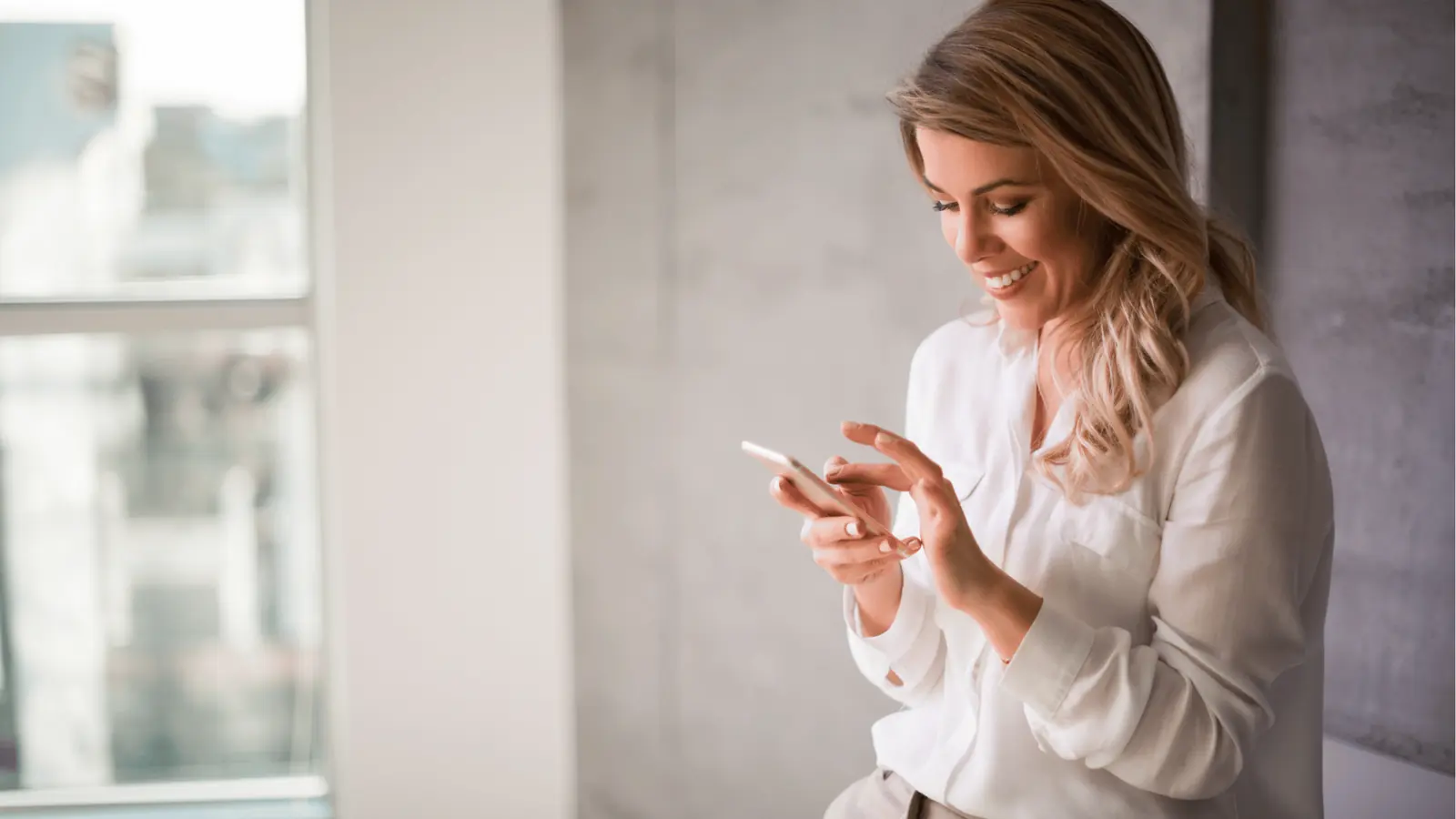 Smiling woman using her smartphone