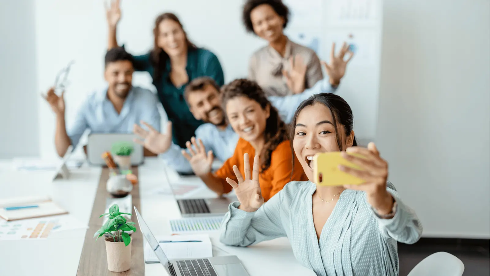 Marketing team smiling together for an office selfie