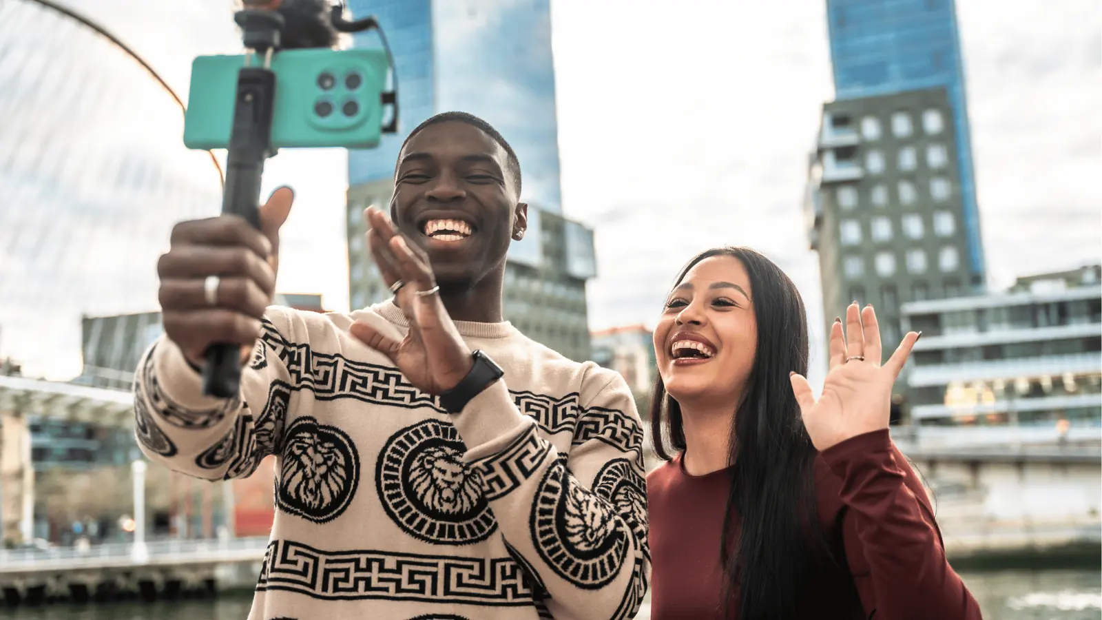 Two colleagues smiling for a city selfie