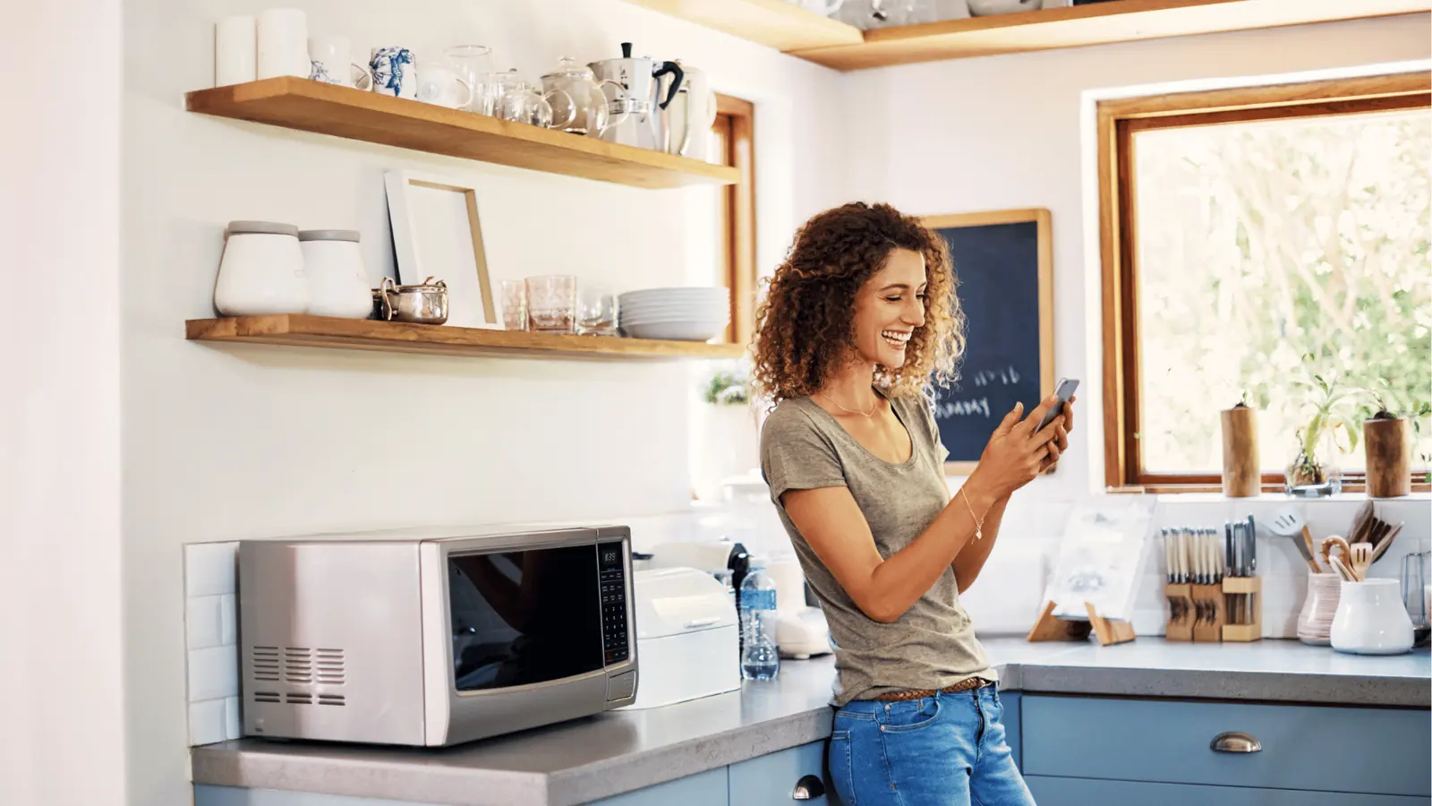 Woman checking her Instagram audience activity data on her phone at home