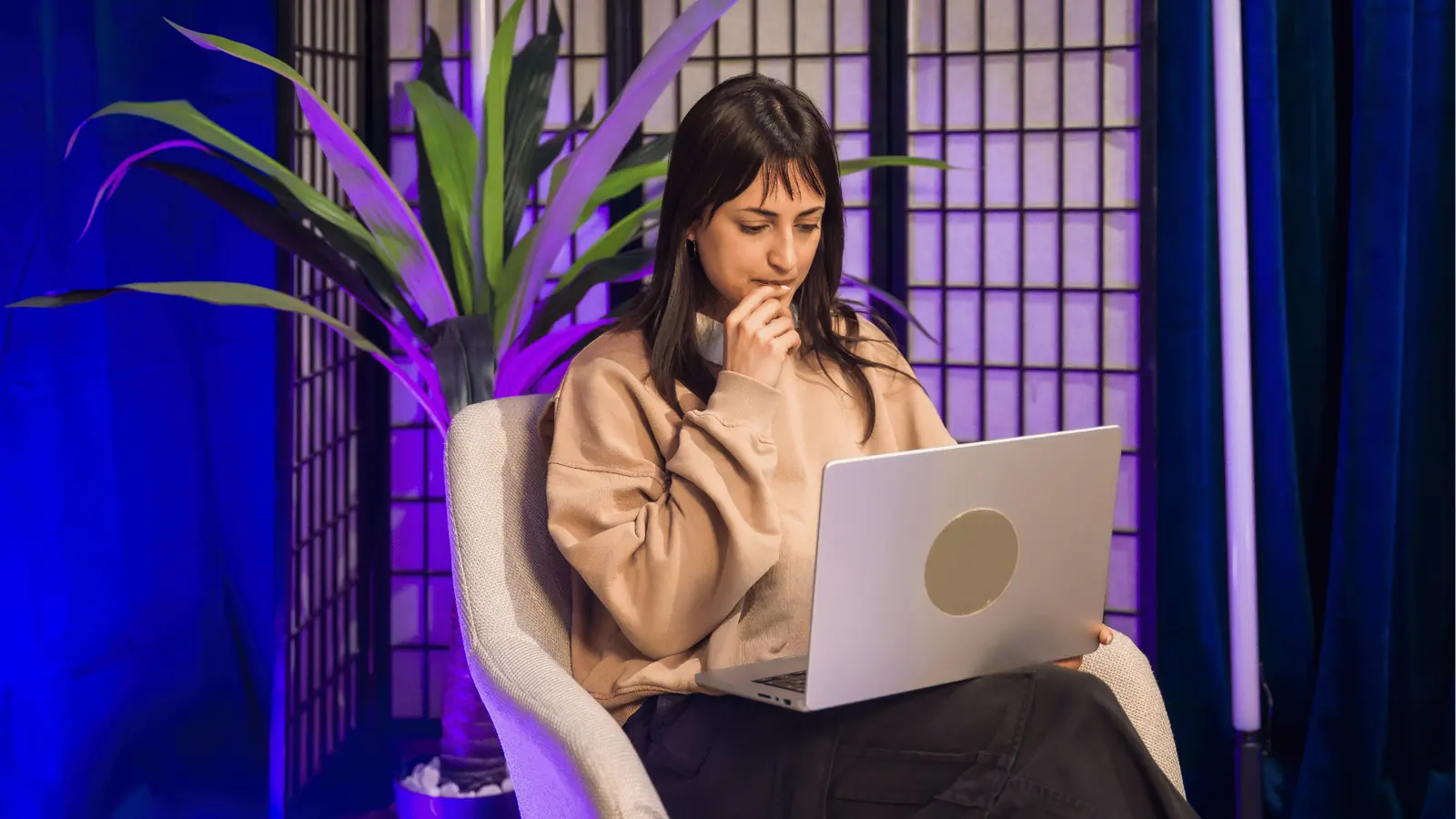 Social media manager working on a laptop, reviewing a shared content calendar